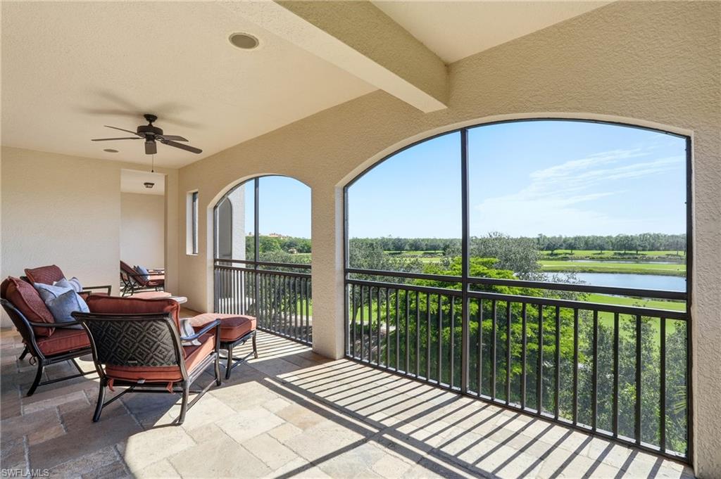 2546 Marquesa Royale Lane, Unit 7302 Naples, FL 34109 - Photo 40 of 46 a view of a balcony with furniture and floor to ceiling window