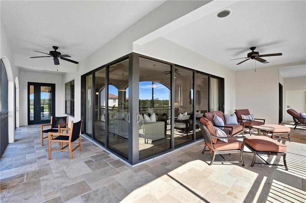 2546 Marquesa Royale Lane, Unit 7302 Naples, FL 34109 - Photo 41 of 46 a living room with patio