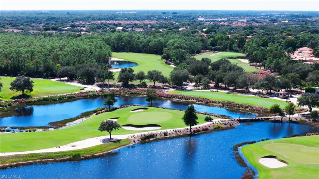 2546 Marquesa Royale Lane, Unit 7302 Naples, FL 34109 - Photo 44 of 46 an aerial view of a house with a swimming pool a yard and lake view