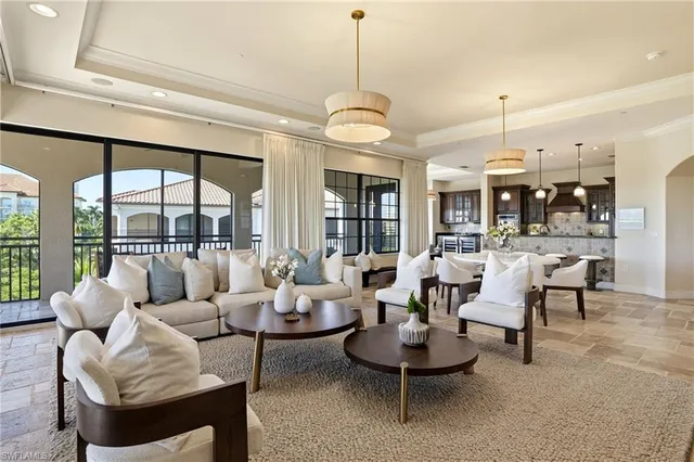 a living room with fireplace furniture and a large window