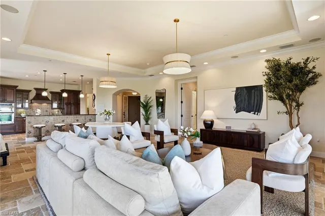 a living room with furniture a flat screen tv and a large window