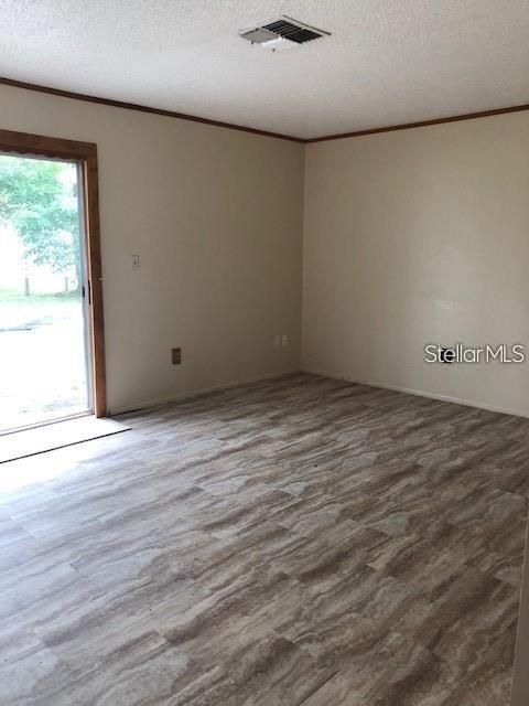1271 Markham Avenue Spring Hill, FL 34606 - Photo 2 of 6 an empty room with wooden floor