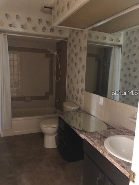 1271 Markham Avenue Spring Hill, FL 34606 - Photo 6 of 6 a bathroom with a granite countertop sink a toilet and bathtub