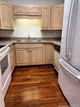 a kitchen with granite countertop a sink and cabinets