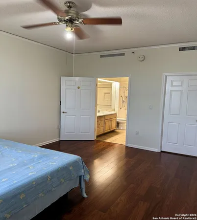 a bedroom with bed and wooden floor