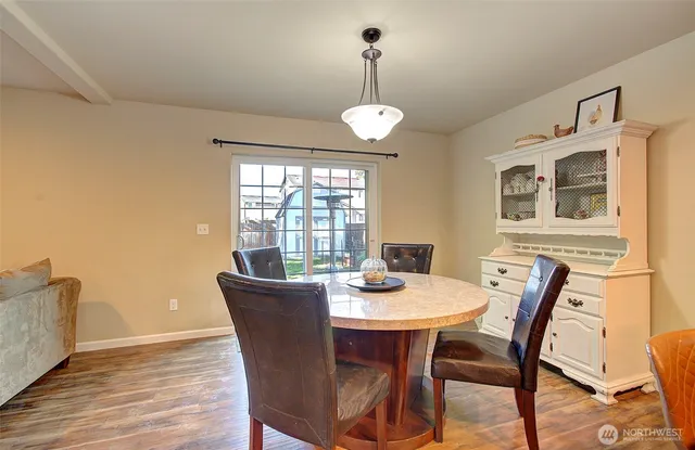 a view of a dining room with furniture window and wooden floor