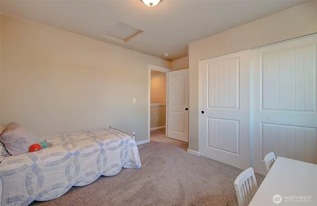 a bedroom with a bed and a desk