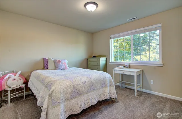 a bedroom with a bed and a chair