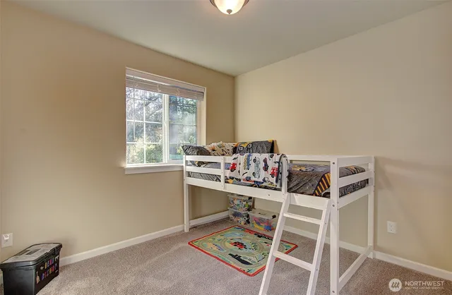 a bedroom with baby crib and book shelf