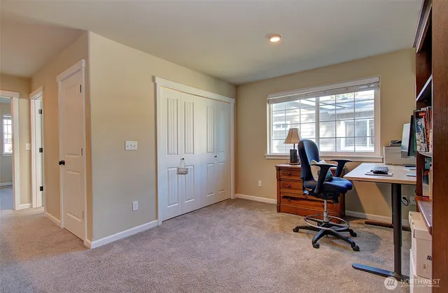 a view of a workspace with furniture and a workspace