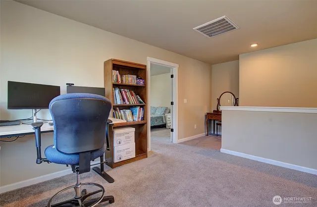 a view of a livingroom with workspace and a window