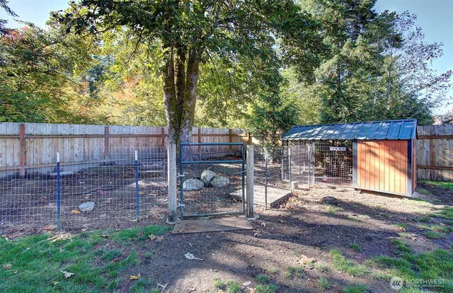 a backyard of a house with table and chairs