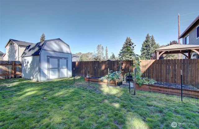 a view of a big house with a big yard and large tree