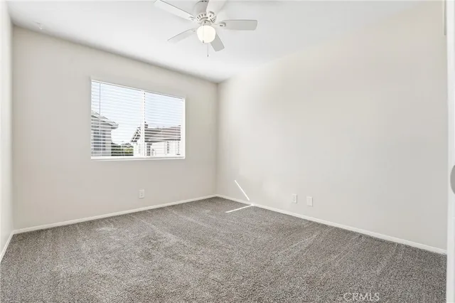 an empty room with a ceiling fan