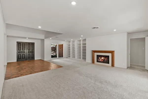 a view of a livingroom with a fireplace and window