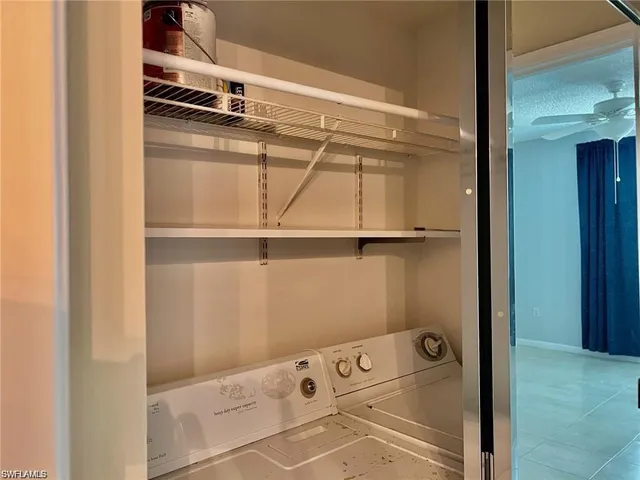 storage and utility room with cabinet