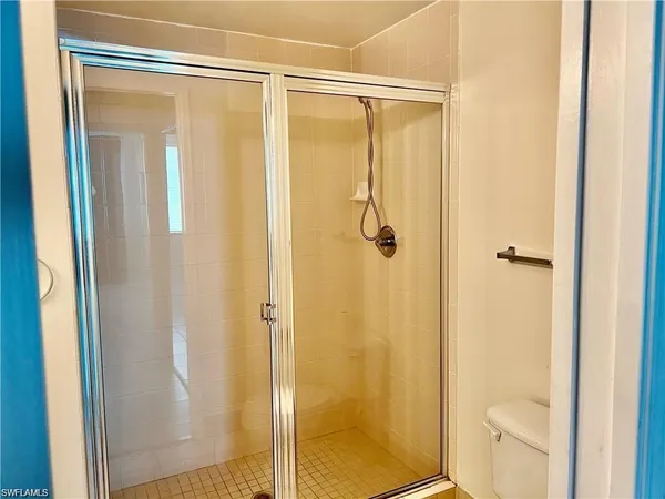 a bathroom with a shower and a toilet