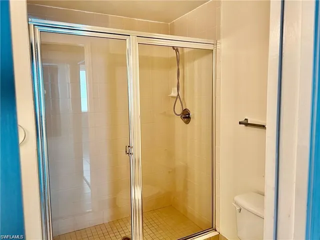 a bathroom with a shower and a toilet