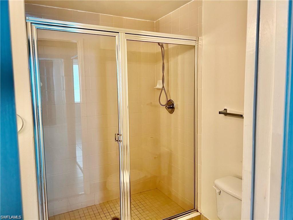 1115 Reserve Court, Unit 2201 Naples, FL 34105 - Photo 9 of 18 a bathroom with a shower and a toilet
