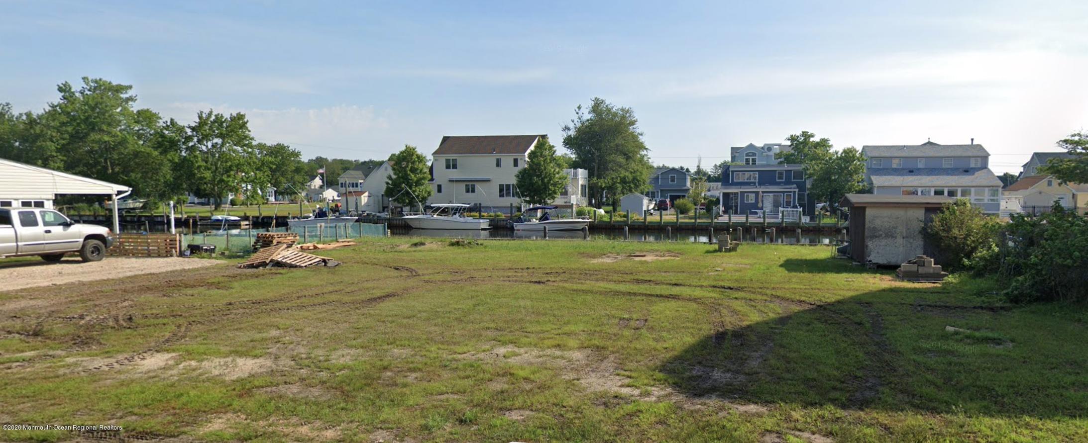 a view of swimming pool with outdoor seating and covered with trees