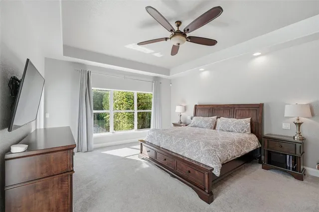 a spacious bedroom with a bed and a large window