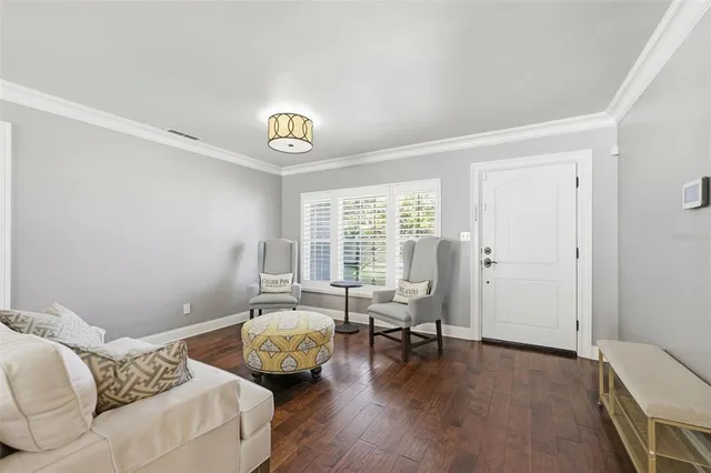 a living room with furniture and two window