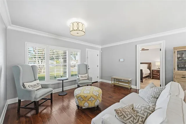 a living room with furniture and wooden floor