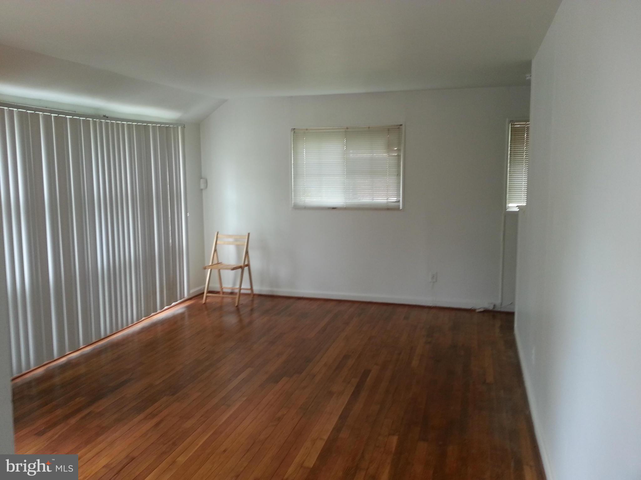 12701 Gould Road Silver Spring, MD 20906 - Photo 8 of 30 a view of an empty room with wooden floor and a window
