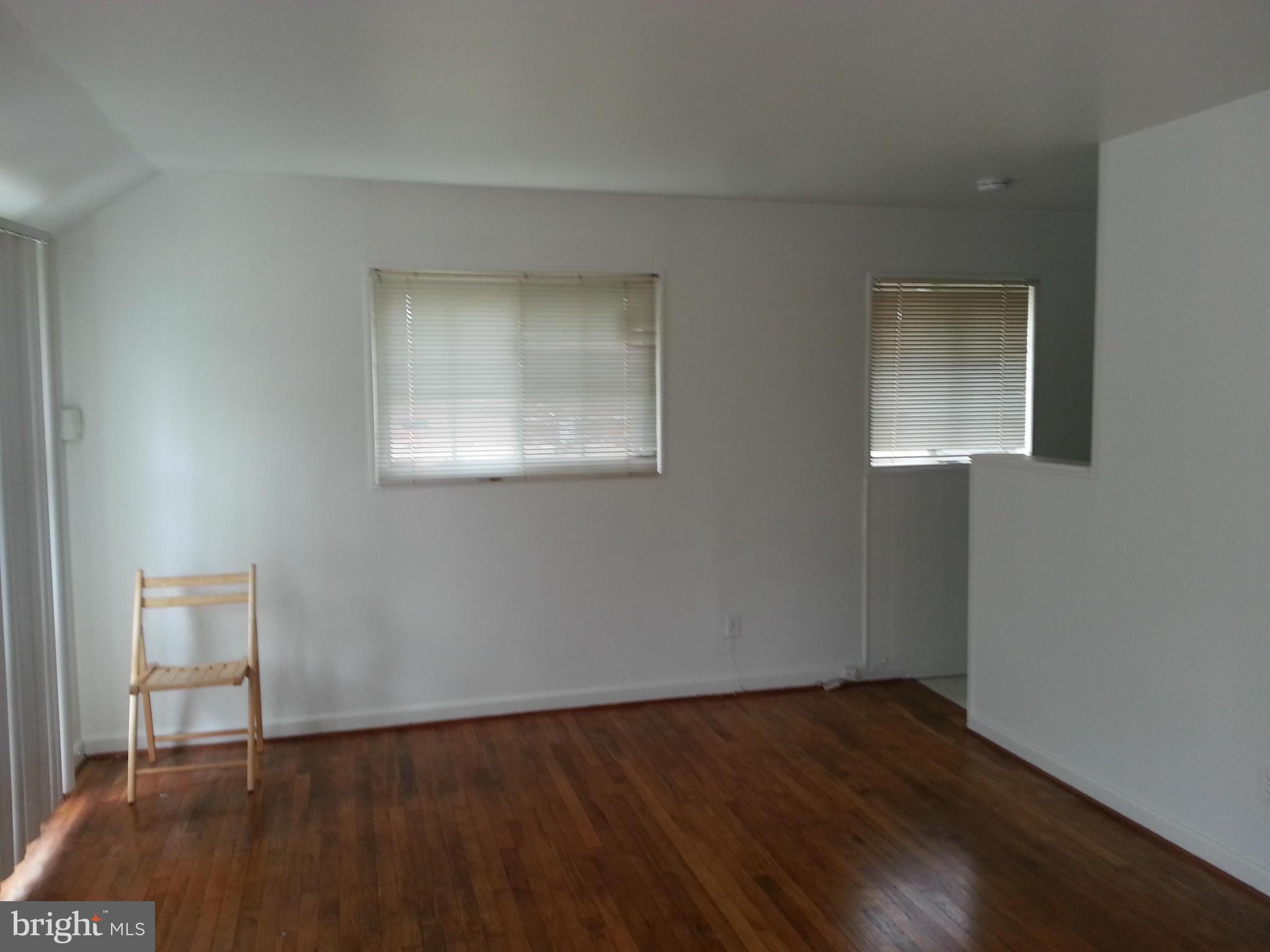 12701 Gould Road Silver Spring, MD 20906 - Photo 9 of 30 a view of an empty room with wooden floor and a window