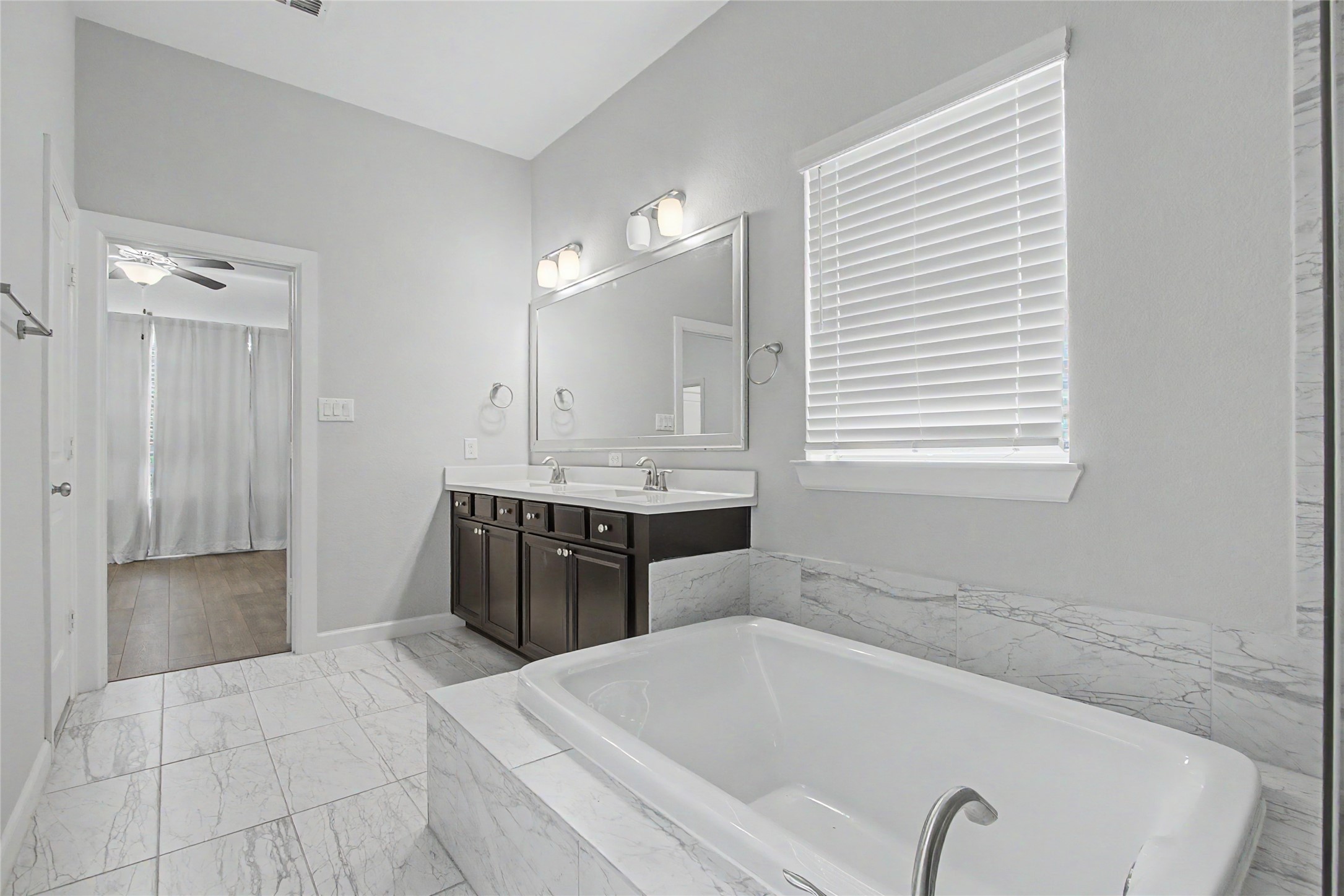 19718 Shinnery Ridge Court Cypress, TX 77433 - Photo 13 of 23 a bathroom with a tub sink and mirror
