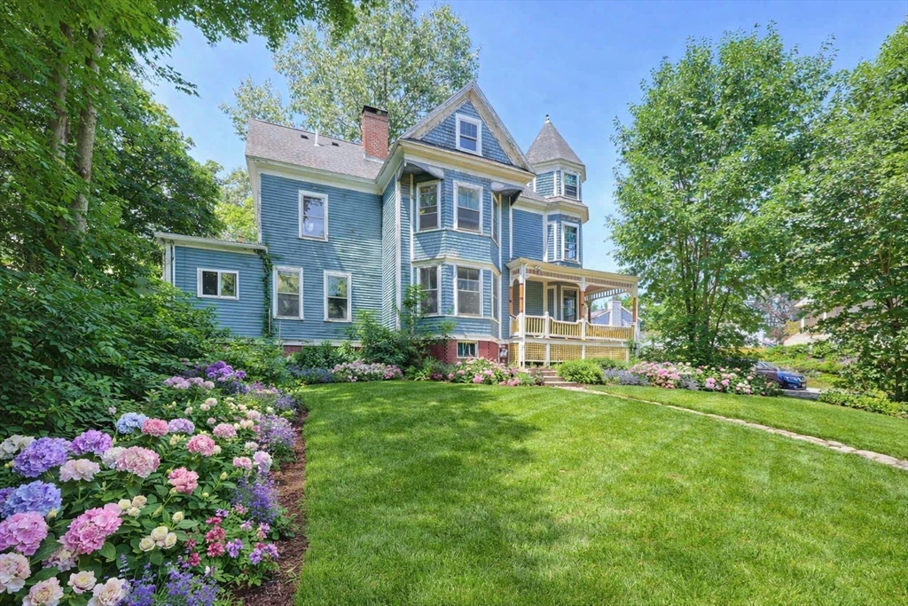7 Baker Street Worcester, MA 01603 - Photo 3 of 42 a view of a house with a big yard and large trees