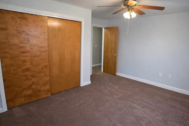 an empty room with a empty space and a ceiling fan