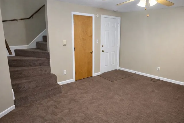 a view of an empty room with stairs and ventilation
