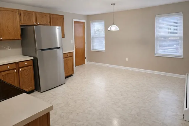 a kitchen with stainless steel appliances a refrigerator and a refrigerator