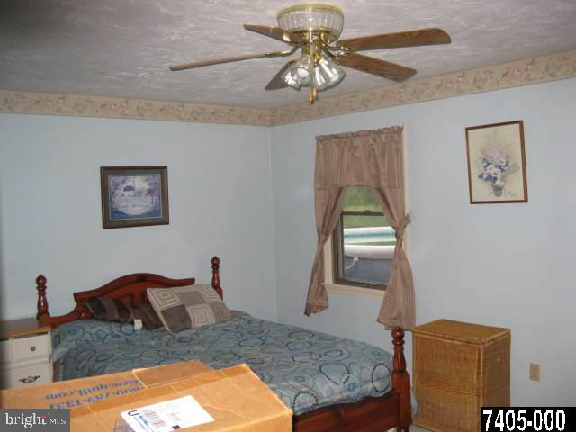 263 White Hall Road Littlestown, PA 17340 - Photo 13 of 16 a bedroom with a bed and a chandelier