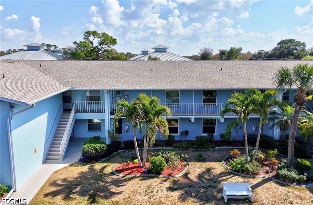 a front view of a house with a yard potted plants