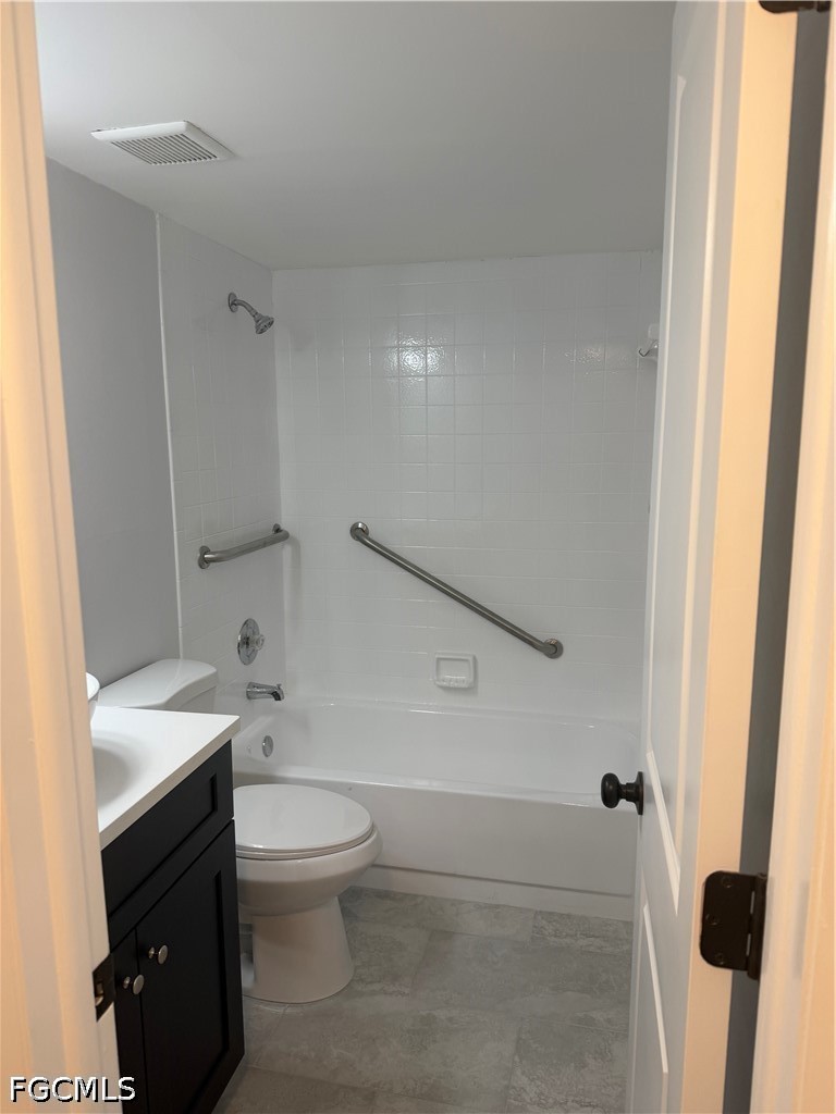 1100 Pondella Road, Unit 703 Cape Coral, FL 33909 - Photo 14 of 16 a bathroom with a sink a toilet and a mirror