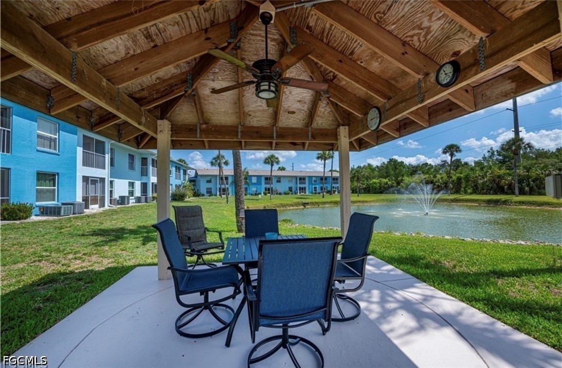 1100 Pondella Road, Unit 703 Cape Coral, FL 33909 - Photo 4 of 16 a view of a patio with a table chairs and a small yard