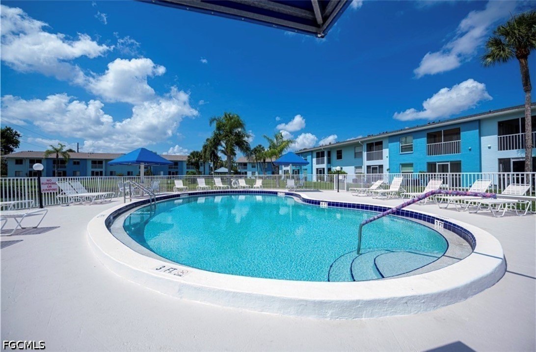 1100 Pondella Road, Unit 703 Cape Coral, FL 33909 - Photo 5 of 16 a view of a swimming pool and a chairs