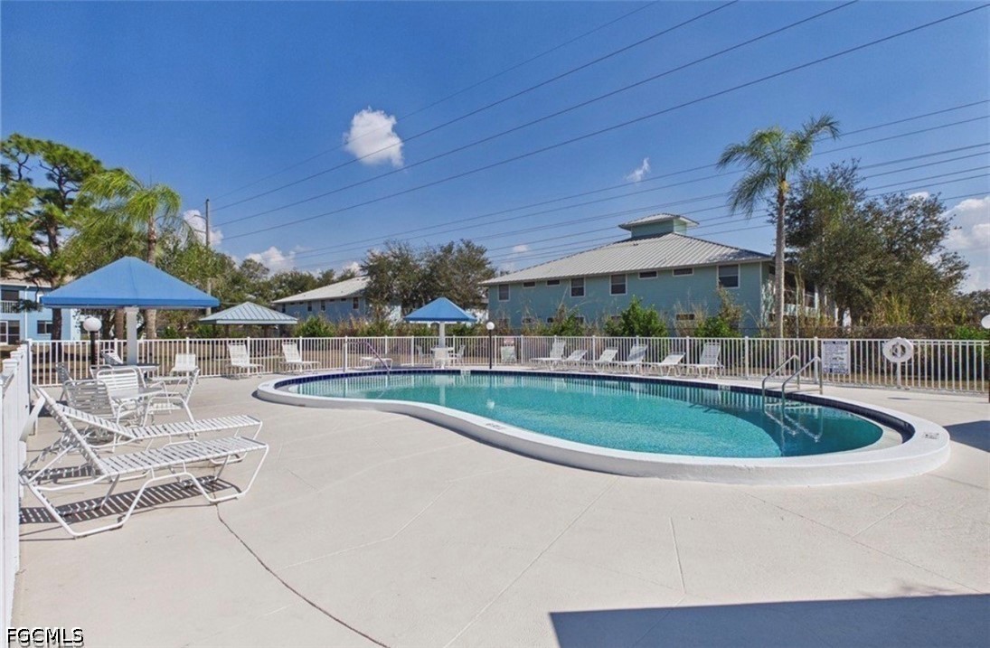 1100 Pondella Road, Unit 703 Cape Coral, FL 33909 - Photo 6 of 16 a view of a swimming pool with a patio