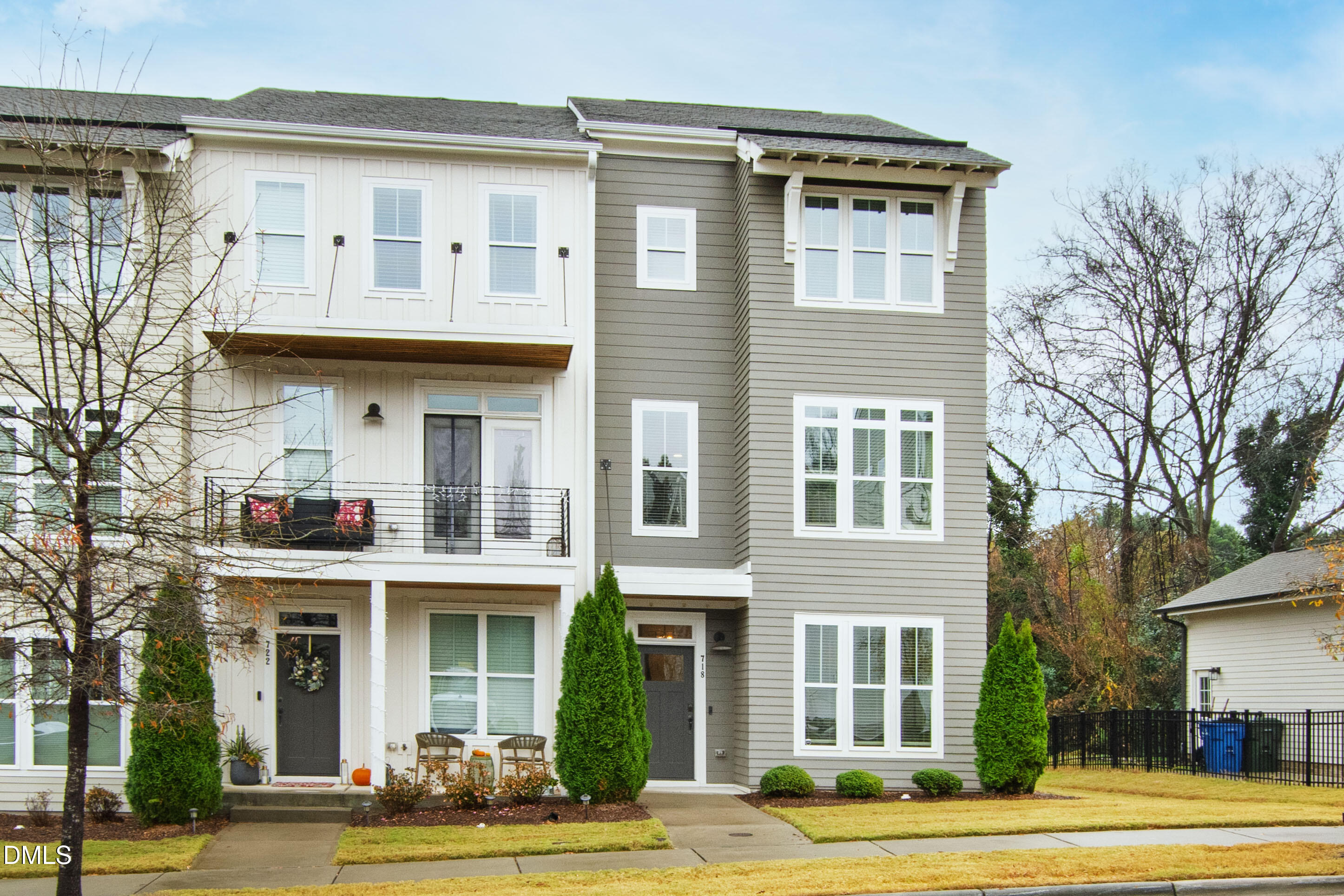 a front view of a residential apartment building with a yard
