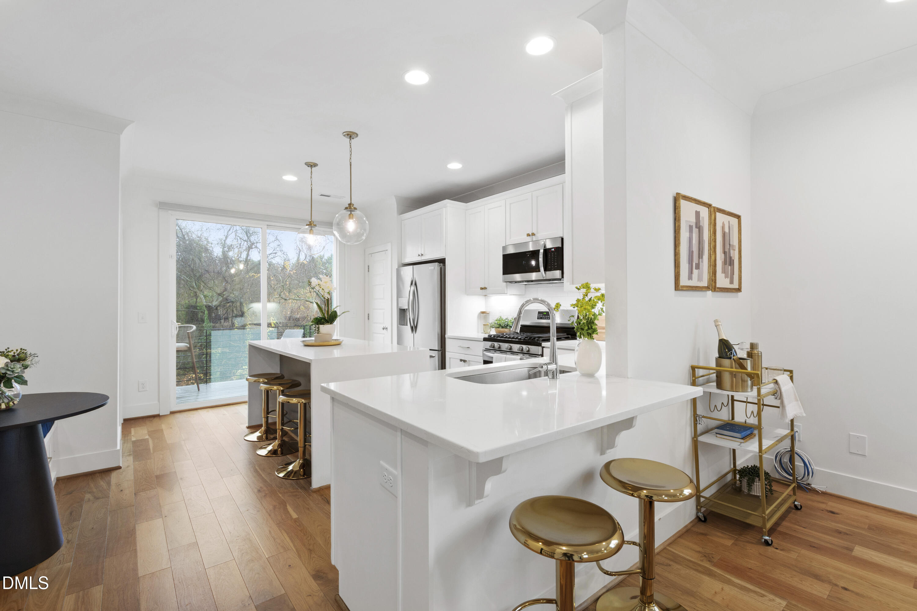 718 Peakland Place Raleigh, NC 27604 - Photo 21 of 48 a kitchen with stainless steel appliances kitchen island granite countertop a table chairs and a refrigerator
