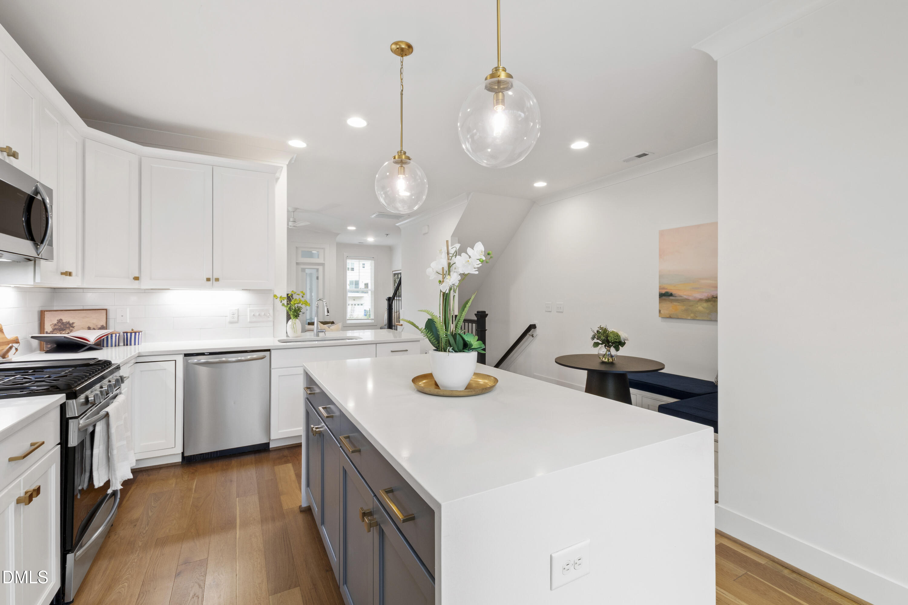 718 Peakland Place Raleigh, NC 27604 - Photo 23 of 48 a kitchen with a sink a stove and chairs