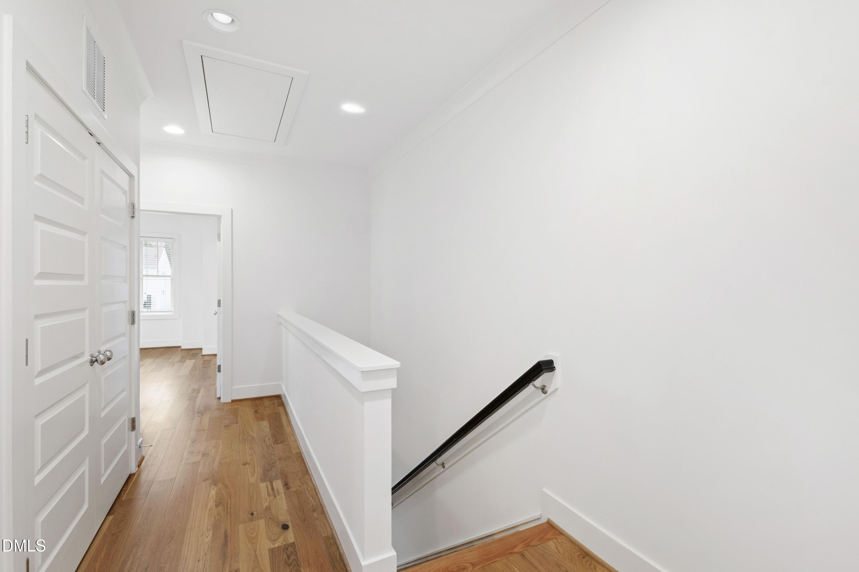 718 Peakland Place Raleigh, NC 27604 - Photo 28 of 48 a view of a hallway with wooden floor and staircase
