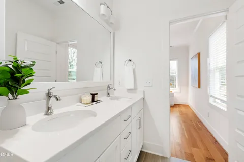 a bathroom with a double vanity sink and a mirror