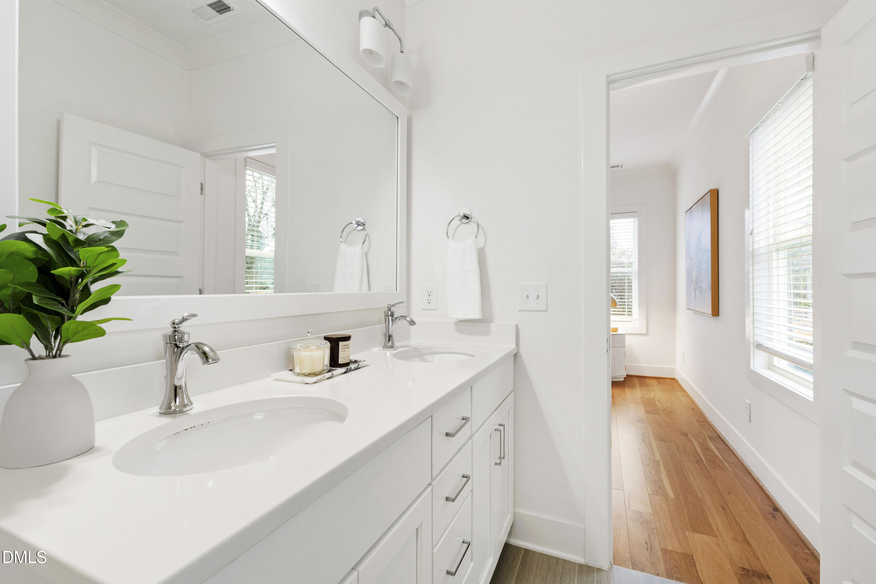 718 Peakland Place Raleigh, NC 27604 - Photo 32 of 48 a bathroom with a double vanity sink and a mirror