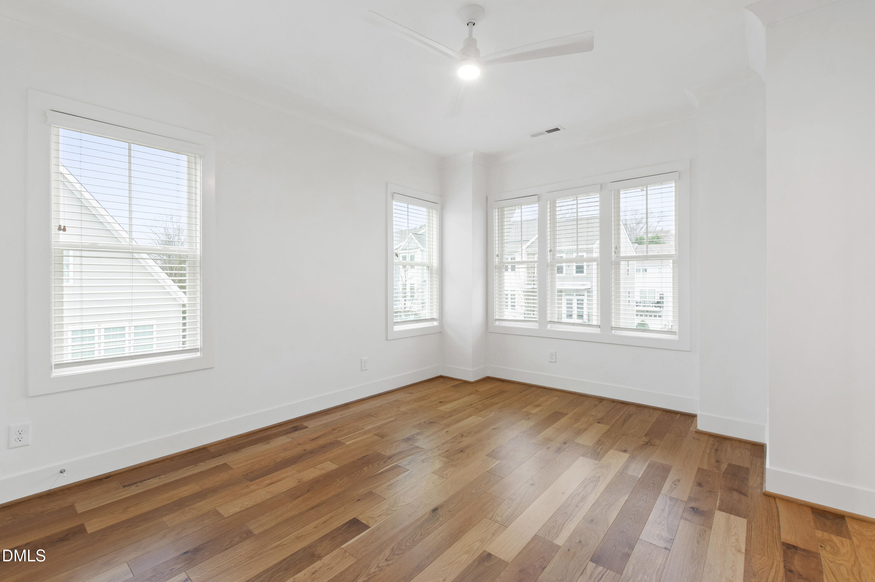 718 Peakland Place Raleigh, NC 27604 - Photo 34 of 48 a view of an empty room with wooden floor and a window