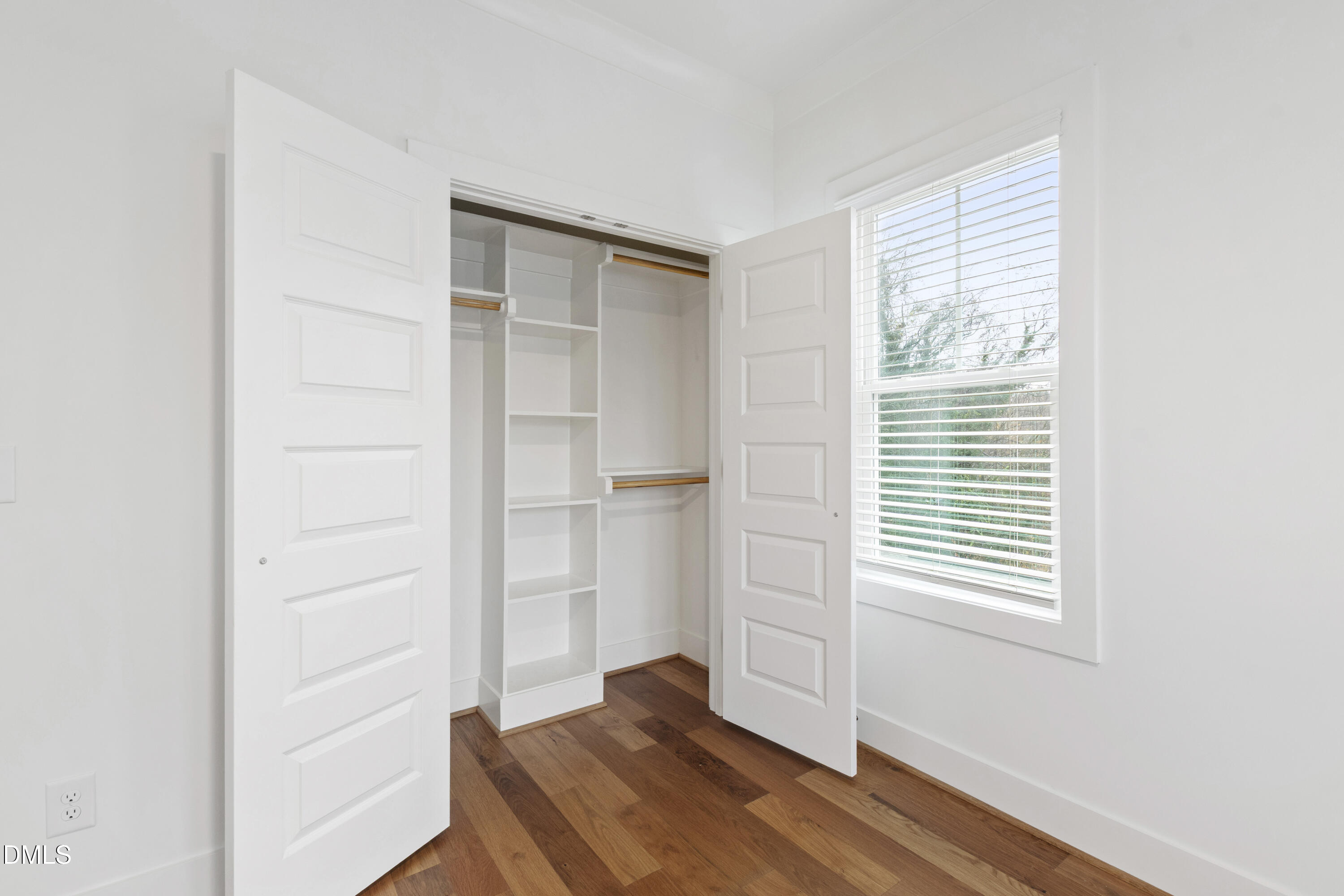 718 Peakland Place Raleigh, NC 27604 - Photo 36 of 48 a view of an empty room with wooden floor and a window