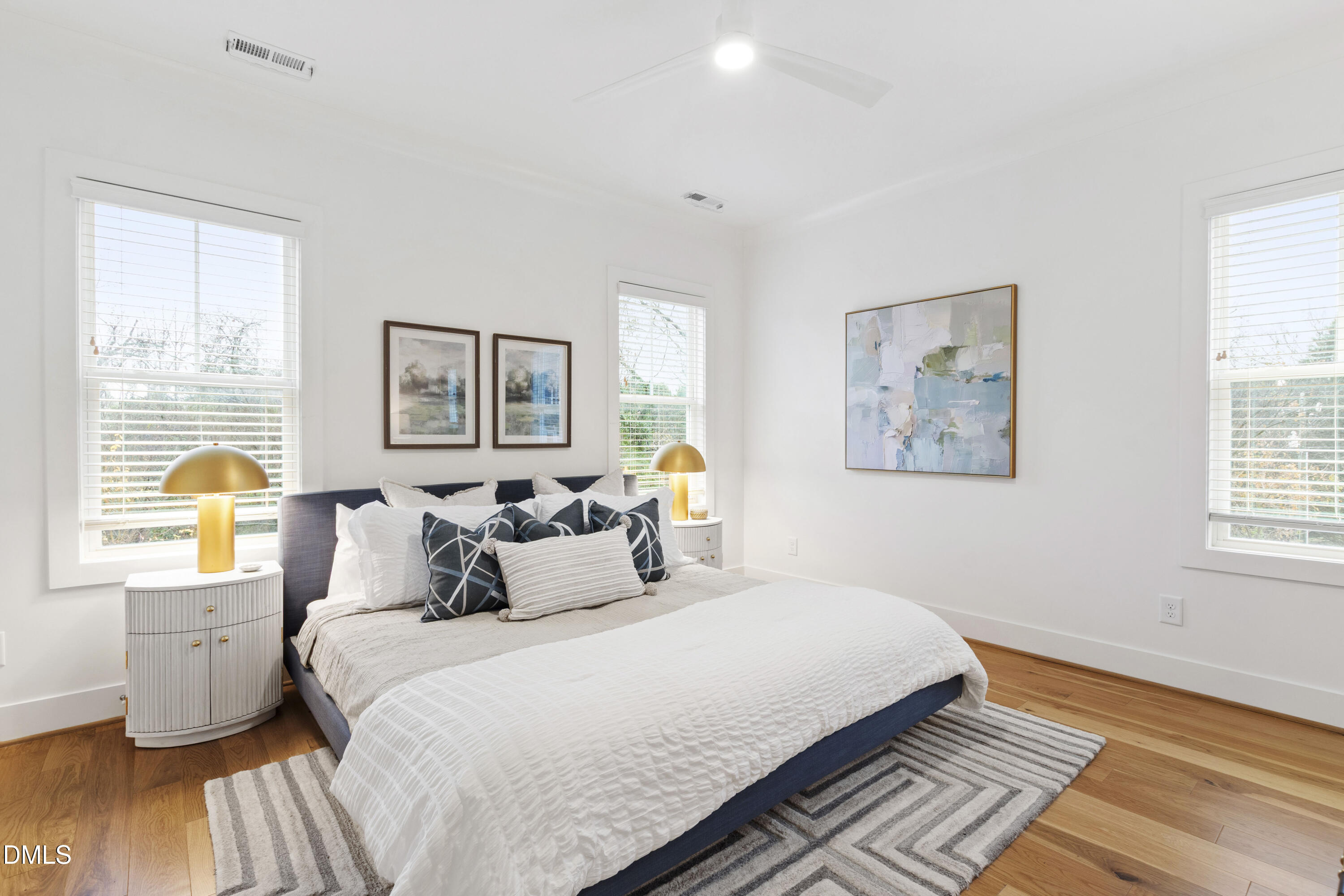 718 Peakland Place Raleigh, NC 27604 - Photo 5 of 48 a bedroom with a bed and wooden floor