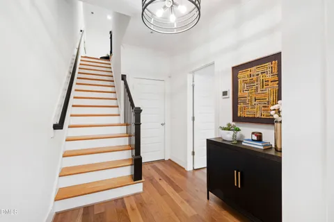 a view of a hallway with wooden floor and workspace